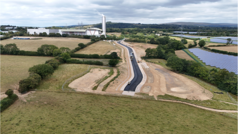 an aerial drone shot of the spine road connecting the freeport with the local area